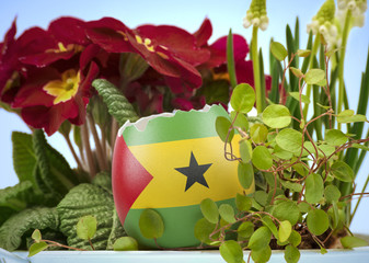 The flag of Sao Tome and Principe on an cracked egg in a floral scene.(series)