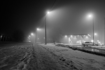 Gas station at foggy evening