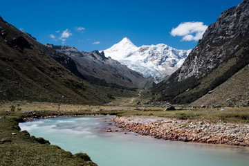 turquoise mountain river and snowy mountain peaks in the Cordillera Blanca in Peru