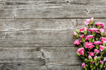 Fototapeta premium Spring bouquet on table on wooden background, flowers on wood, top view, flat lay