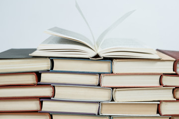 Chaotic stack of old books pastel colors, selective focus with copy space