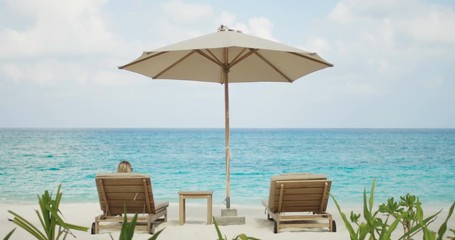 Back View of Woman Sunbathing on a Beach, She's Lying on the Deck Chair with a Beautiful Sea View - Powered by Adobe