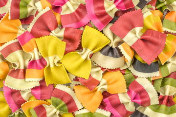 Farfalle pasta with vegetables background top view raw classic traditional Italian colourful.