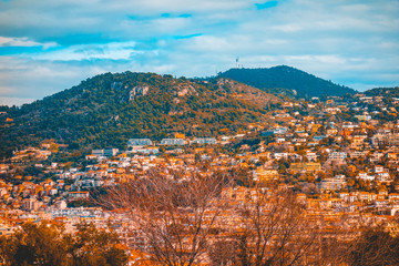 Fototapeta na wymiar warm colored city overview at nice, france with orange houses and mountains in the background