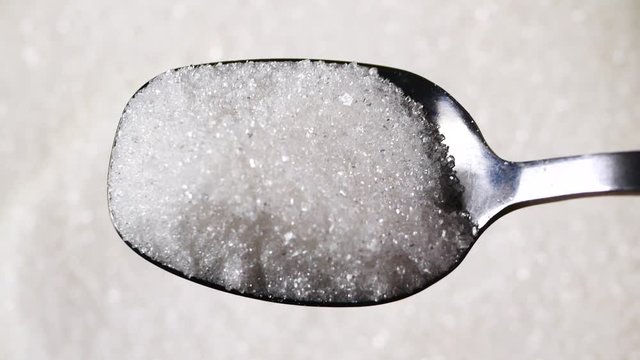 Silver spoon scoops up sugar