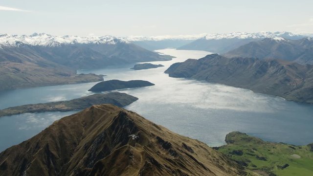 White helicopter flying over Lake Wanaka, New Zealand.