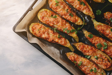 Baked stuffed zucchini with meat in a pan