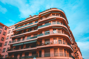 Obraz premium red colored corner house with curved balcony