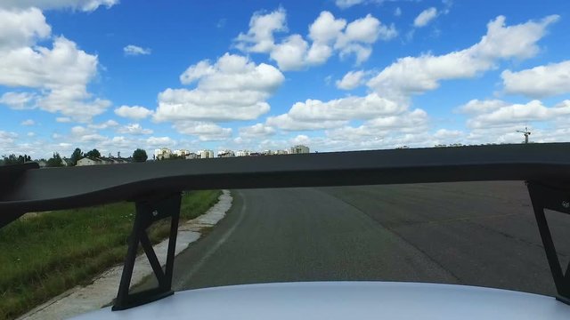 Tuned speed auto with spoiler behind in race competition, technical benefit