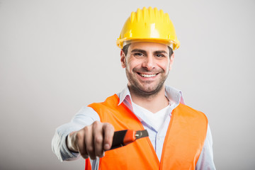 Portrait of handsome architect holding cutter tool