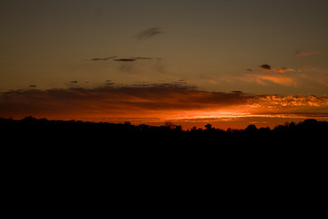 Silhouette of Orange Horizon with Clouds