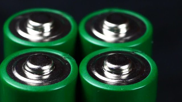 Batteries in extreme close up UHD stock footage. A collection of AA batteries in true macro close up with a sliding camera move