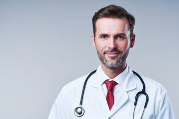 Portrait of male doctor isolated on grey background