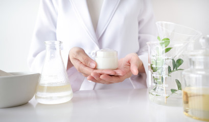 the scientist,dermatologist make the organic natural herb cosmetic product in the laboratory. beauty healthy skincare concept. herb medicine ,blank package,bottle,container.cream,serum.