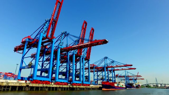 Container ships unload or load their cargo in the Port of Hamburg at the Burchartkai and Eurokai, Germany.