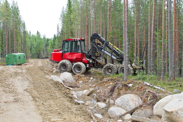 Harvesting machine near the forest path waiting before next work. Wood industry in Russia