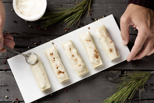man preparing meat stuffed cannelloni