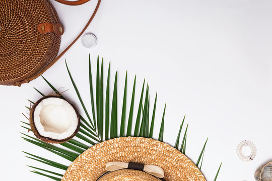 Feminine accessories, greem leaves and half of the coconut.
