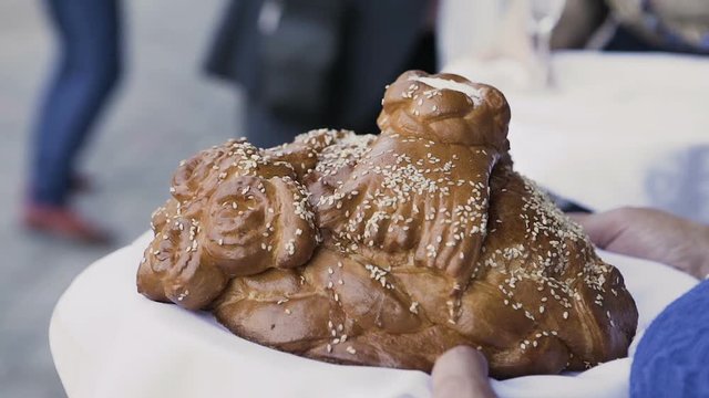 Fresh bread with salt inside holds a woman