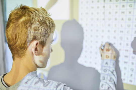 Student in class at interactive whiteboard