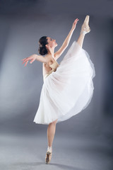 Fototapeta na wymiar Beautiful slim woman ballet dancer in studio