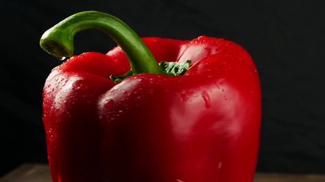 Sweet red pepper on black background close up