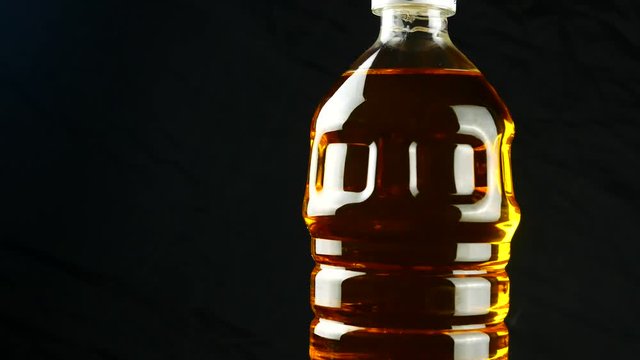 oil in plastic bottle on black background