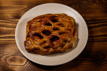 Delicious cherry strudel on wooden table