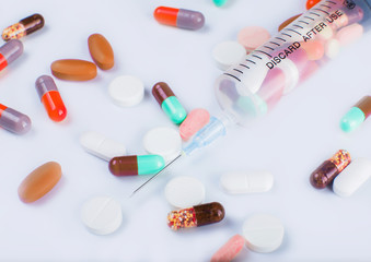 Medicine pills with syringe on white background drug prescription for treatment