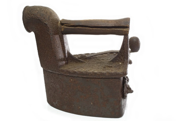 Vintage antique iron with traces of rust on a white background. Metal Iron on coals. Collectible....