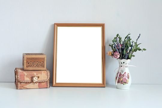 Mockup 8x10 wooden frame with boxes and flowers