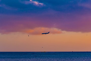 Fototapeta na wymiar brilliant sunset over the port of Aruba in the Caribbean sea with ships and planes landing