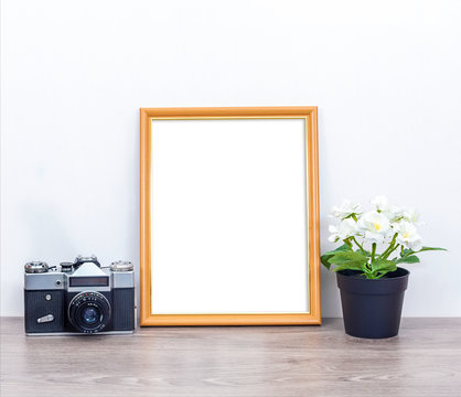 A minimalistic 8x10 mockup with a camera and flowers