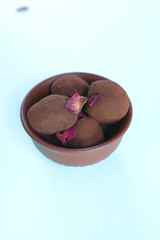 Homemade delicious  and intense dark chocolate truffles in adorable clay bowl.