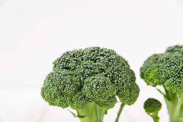 fresh broccoli.white background.minimalist style.creative food.close-up view