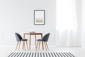 Minimalist dining room with poster