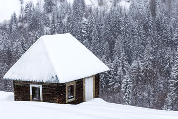 Little wooden houses on Romanian mountains at winter