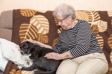 Grandmother on the couch with a dog