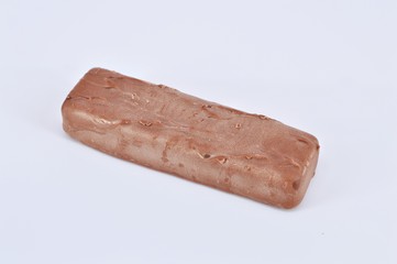 Closeup of chocolate bar on white background. Selective focus.