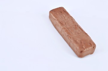 Closeup of chocolate bar on white background. Selective focus.