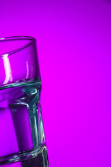 The water in glass on lilac background