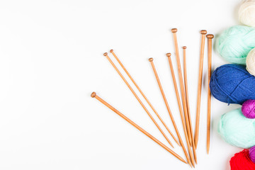 Knitting background frame. Knitting needles and colorful yarn on white background