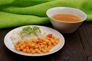 Chickpeas on paprika with rice on a table