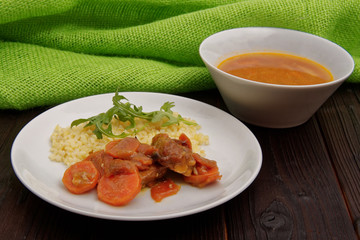 Tempeh with carrot and bulgur on a table
