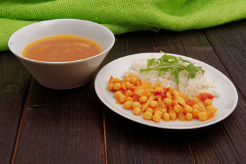 Chickpeas on paprika with rice on a table