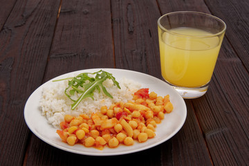 Chickpeas on paprika with rice on a table