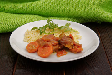 Tempeh with carrot and bulgur on a table