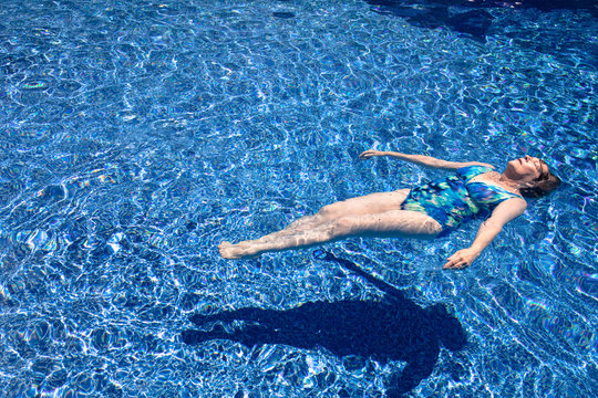 Senior Woman Floating In Pool