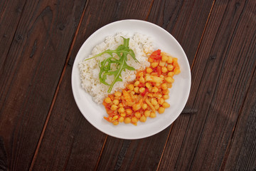 Chickpeas on paprika with rice on a table