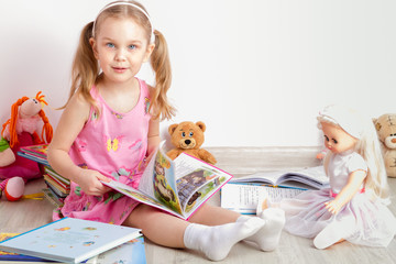 girl reads books to toys